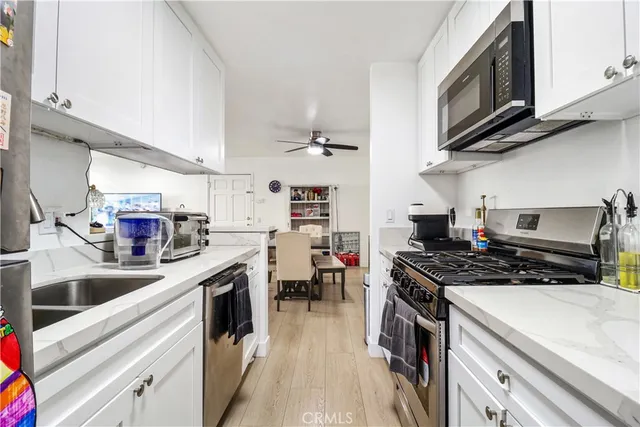 a kitchen with stainless steel appliances granite countertop a stove and a sink