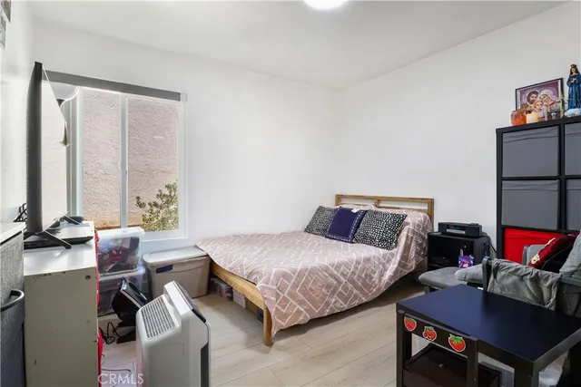 a bedroom with a bed and a couch