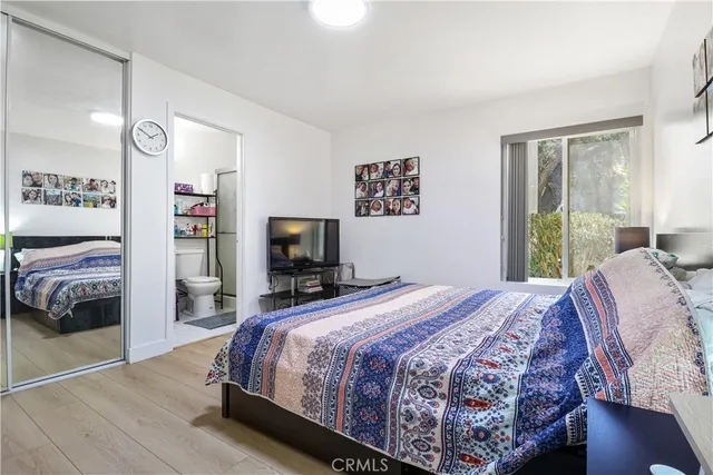 a bedroom with a bed and a television in it