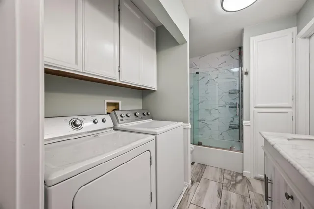 a view of storage and utility room with washer and dryer
