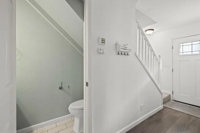 a bathroom with a granite countertop toilet and a shower