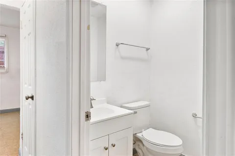 a white toilet sitting next to a bathroom sink