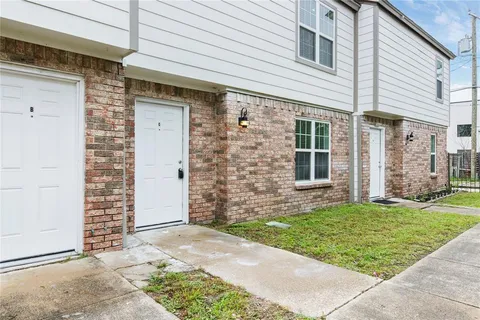 a view of a brick house with a yard