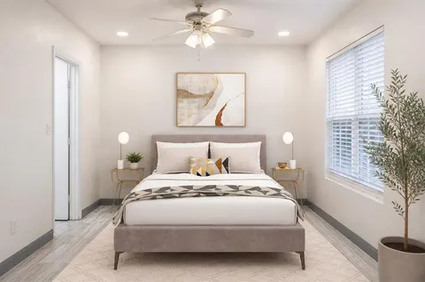 a bedroom with a large bed and a window