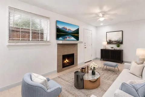 a living room with furniture window and fireplace