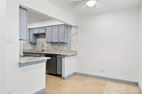 a kitchen with a sink cabinets and wooden floor