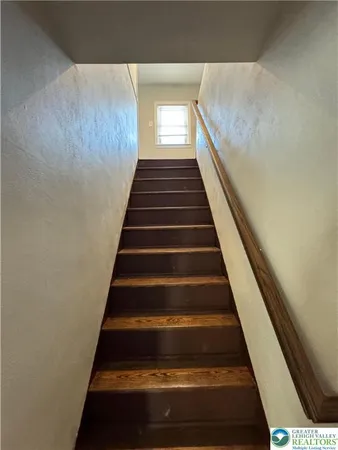 a view of hallway with wooden floor