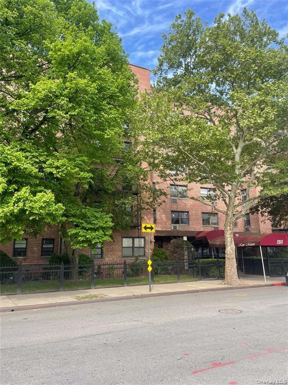 131-11 Kew Gardens Road, Unit 6N Queens, NY 11418 - Photo 2 of 14 front view of a house with a tree