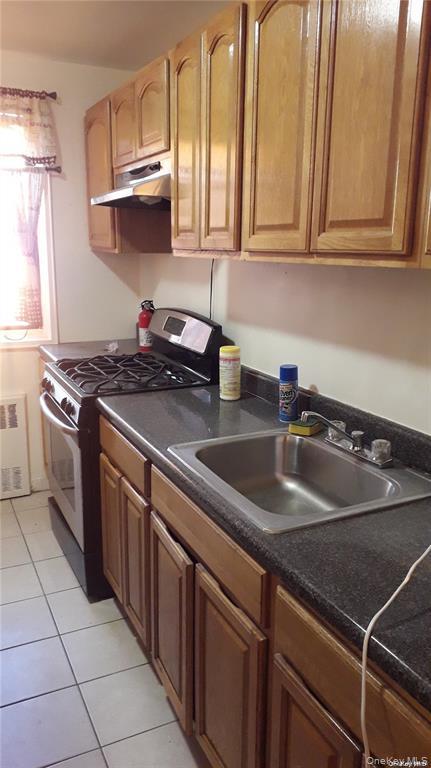 131-11 Kew Gardens Road, Unit 6N Queens, NY 11418 - Photo 3 of 14 a kitchen with stainless steel appliances granite countertop a sink stove and cabinets