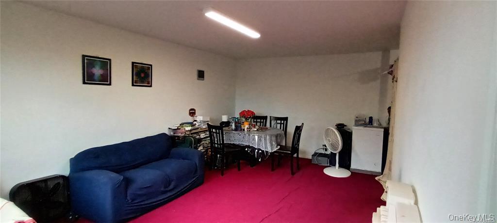 131-11 Kew Gardens Road, Unit 6N Queens, NY 11418 - Photo 6 of 14 a living room with furniture and a gym equipment