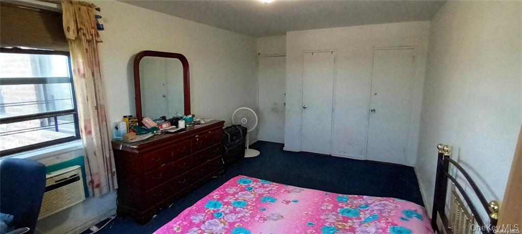 131-11 Kew Gardens Road, Unit 6N Queens, NY 11418 - Photo 9 of 14 a bed room with a bed and a dresser
