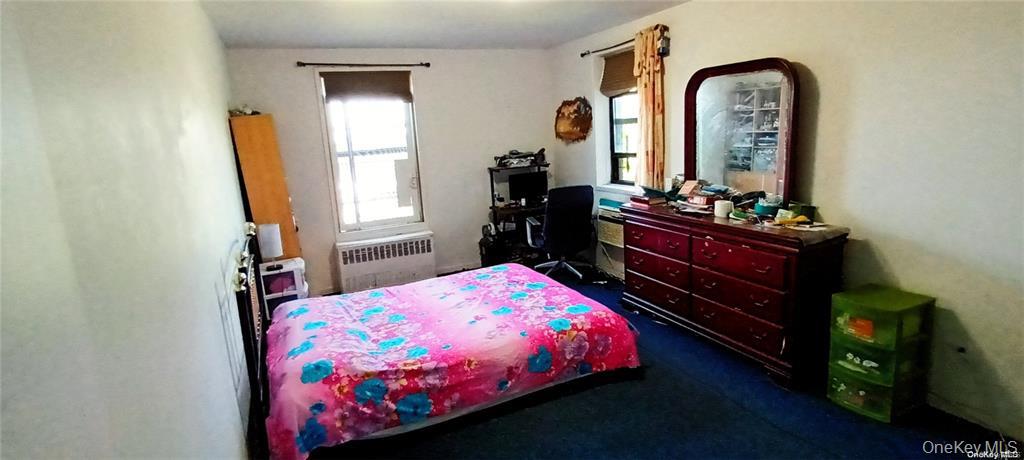 131-11 Kew Gardens Road, Unit 6N Queens, NY 11418 - Photo 10 of 14 a bedroom with a bed and a dresser