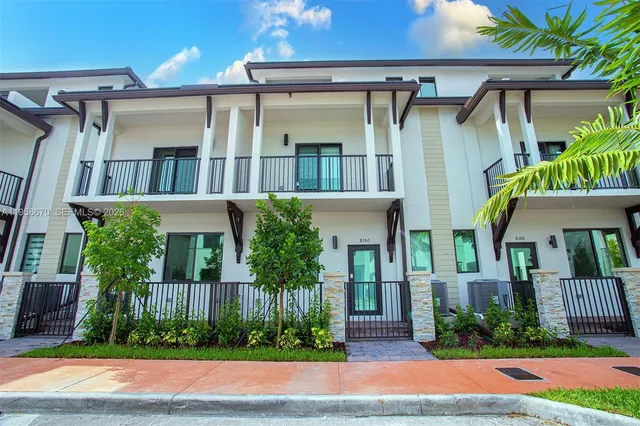 a front view of house and yard with green space