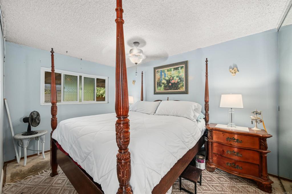 1480 Taylor Avenue Escondido, CA 92027 - Photo 12 of 23 a bedroom with a bed and wooden floor