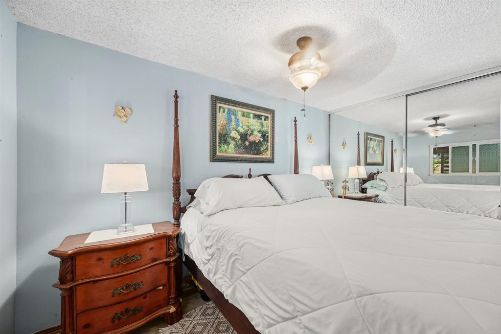 1480 Taylor Avenue Escondido, CA 92027 - Photo 13 of 23 a bedroom with bed and a chandelier