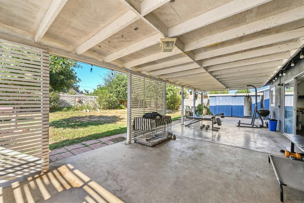 1480 Taylor Avenue Escondido, CA 92027 - Photo 17 of 23 a view of a porch with wooden table and chairs