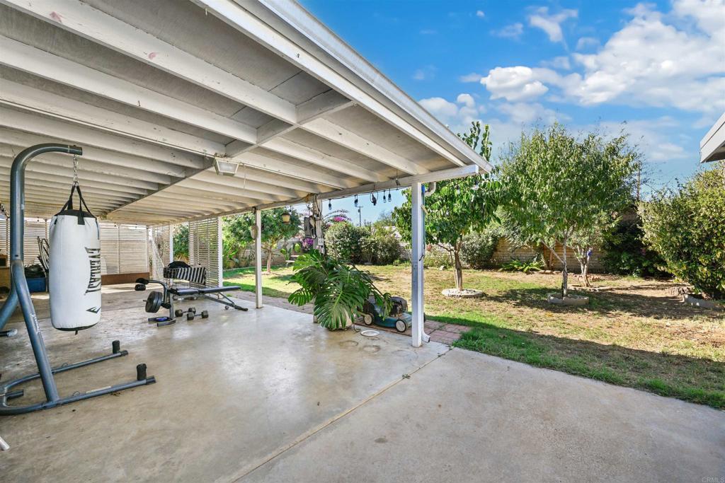1480 Taylor Avenue Escondido, CA 92027 - Photo 19 of 23 a view of a patio with a table and chairs under an umbrella