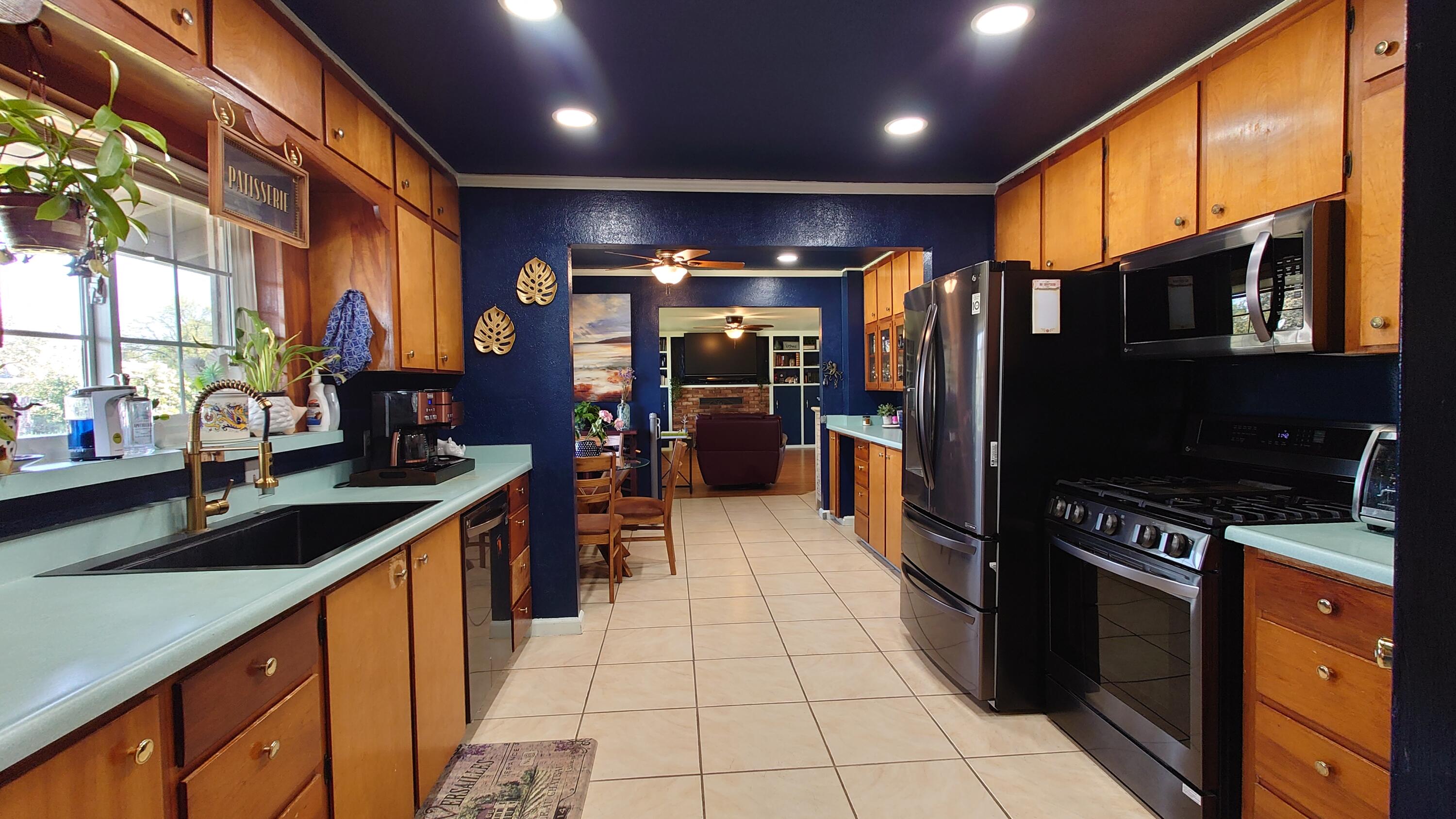 1713 Cascade Lane Redding, CA 96002 - Photo 3 of 12 a kitchen with stainless steel appliances granite countertop a refrigerator and a sink