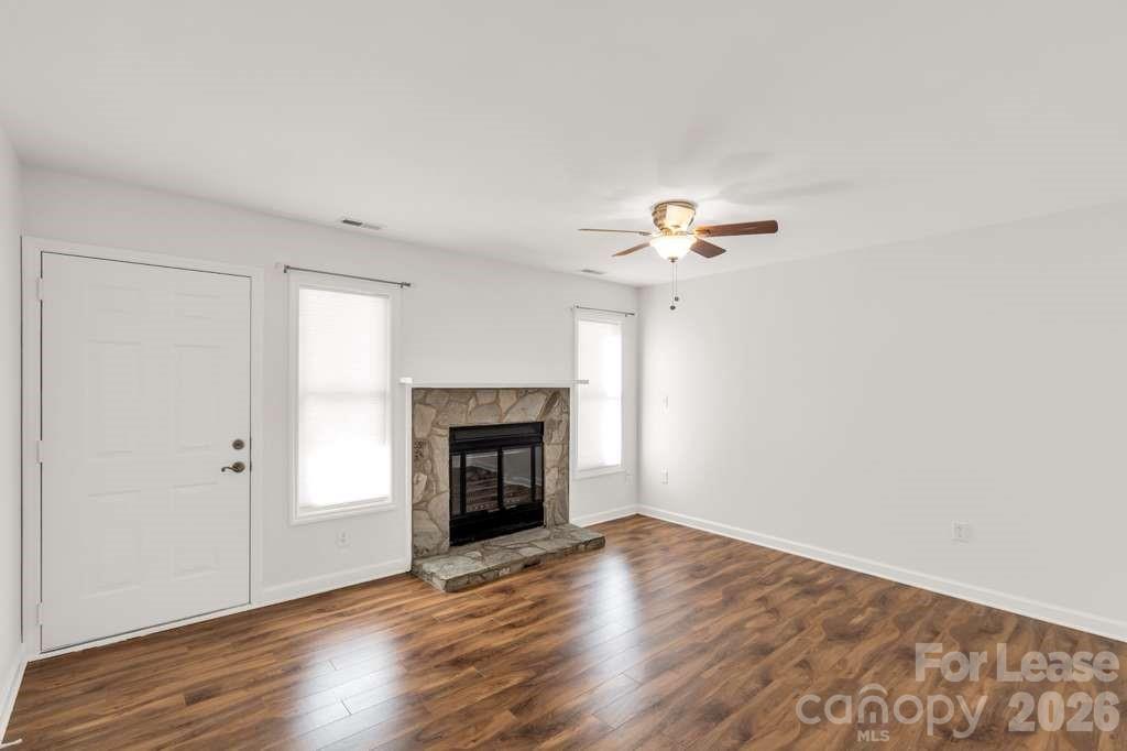 402 Sweetgum Drive Fort Mill, SC 29715 - Photo 2 of 10 a view of an empty room with wooden floor fireplace and a window