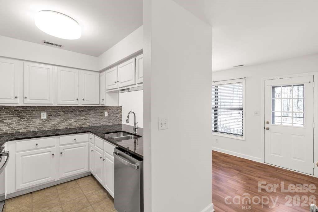 402 Sweetgum Drive Fort Mill, SC 29715 - Photo 7 of 10 a kitchen with granite countertop white cabinets and white appliances