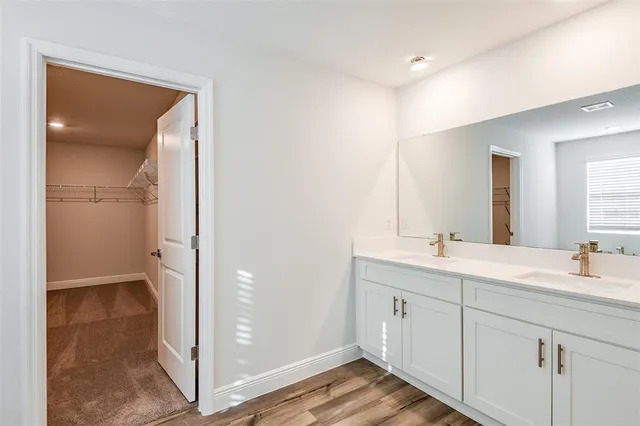 a bathroom with a double vanity sink a mirror and a shower