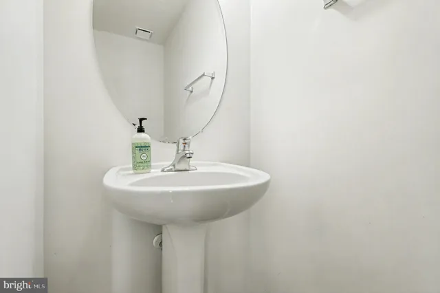 a bathroom with a sink a mirror and vanity