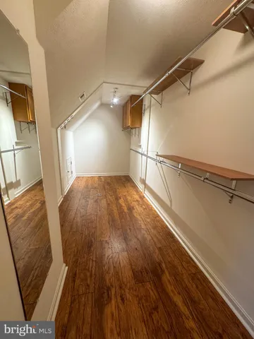 a view of a room with wooden floor