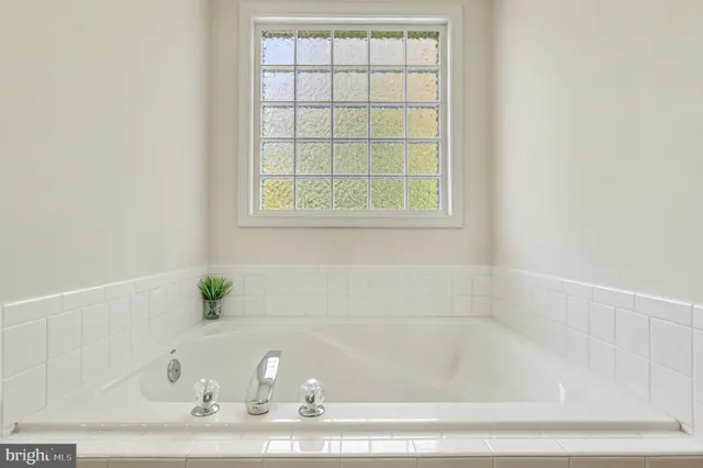 a white bath tub sitting next to a window