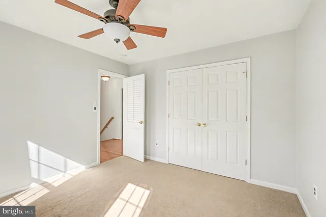a view of a big room with closet and a ceiling fan