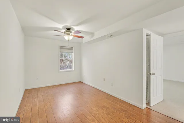wooden floor in an empty room with a window