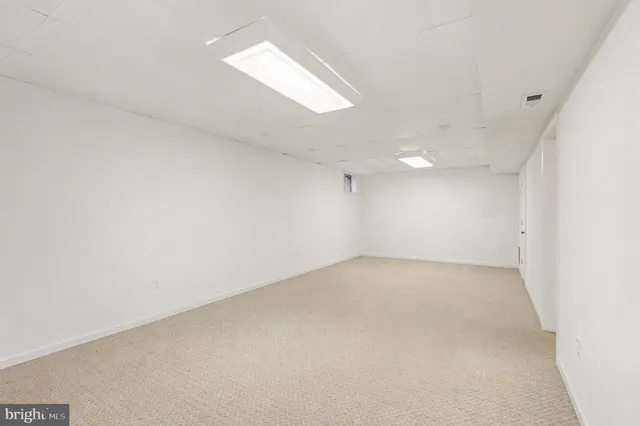 an empty room with a empty space and windows