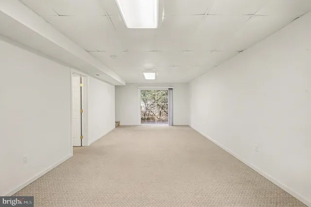 an empty room with a empty space and windows