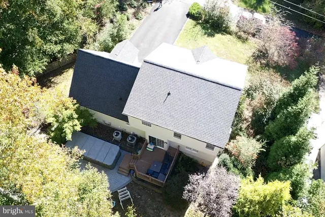 an aerial view of a house with yard and swimming pool
