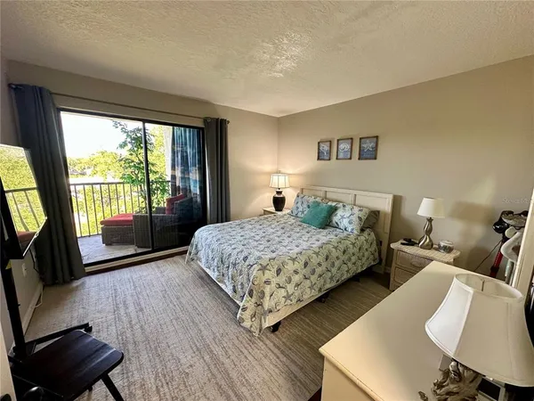 a bedroom with a bed and a television