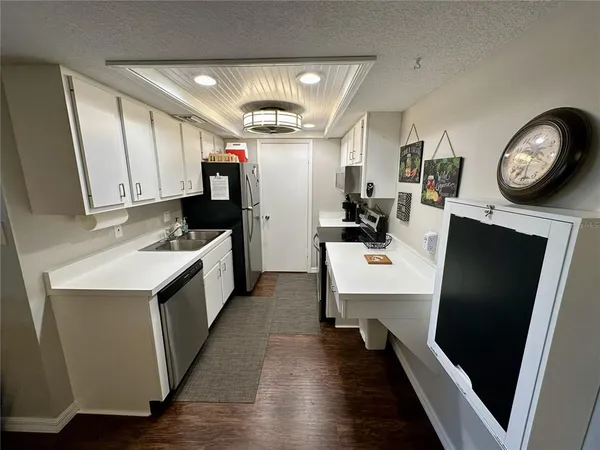 a kitchen with a sink appliances and cabinets