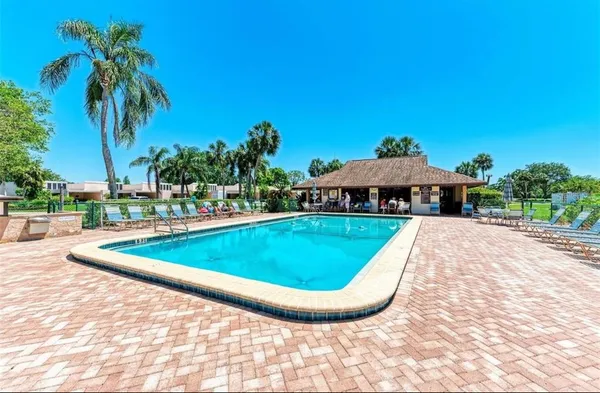 a view of a swimming pool with a yard