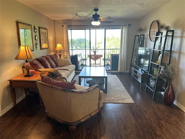 a living room with furniture and a floor to ceiling window