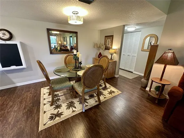 a view of a workspace with furniture and wooden floor