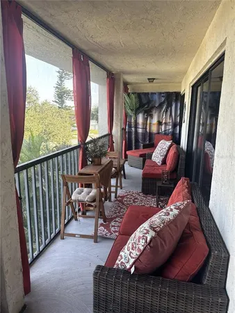 a living room filled with furniture and a floor to ceiling window