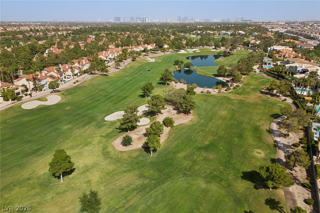 20 Innisbrook Avenue Las Vegas, NV 89113 - Photo 17 of 39 Overlooking a verdant golf course and serene lake, enjoy scenic views of the city skyline.