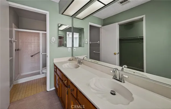 a bathroom with a double vanity sink and a mirror