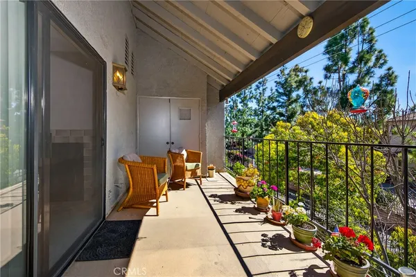 a balcony with beautiful flowers and garden view