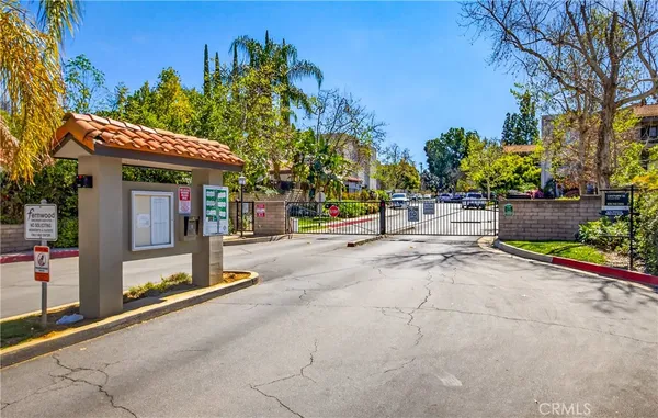 a view of a brick house with large windows of the road