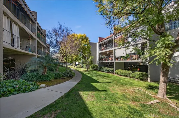 a view of an apartment with a yard