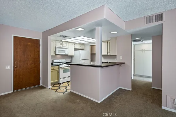 a view of kitchen cabinets and stainless steel appliances