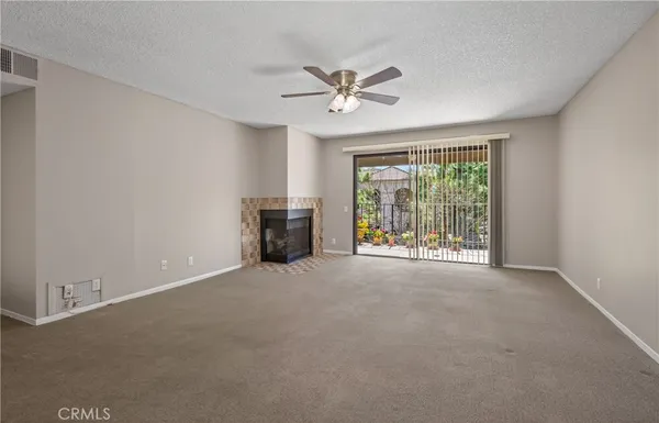 a view of a livingroom with a ceiling fan and window