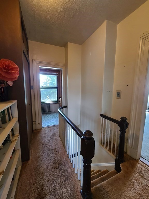 16 Malbert Road Boston, MA 02135 - Photo 11 of 38 a view of a hallway with wooden floor and stairs