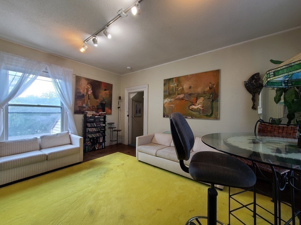 16 Malbert Road Boston, MA 02135 - Photo 13 of 38 a living room with furniture and a flat screen tv