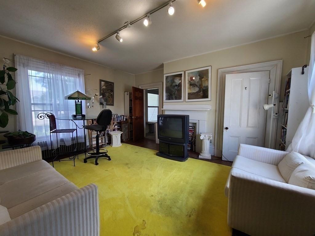 16 Malbert Road Boston, MA 02135 - Photo 14 of 38 a living room with furniture and a fireplace