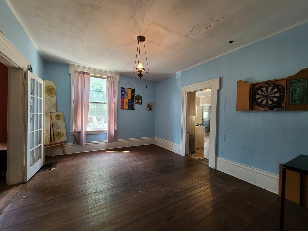 16 Malbert Road Boston, MA 02135 - Photo 22 of 38 a view of an empty room with window and wooden floor